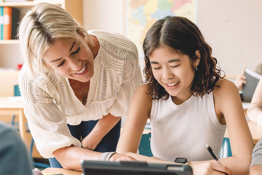 Teacher helping a student.